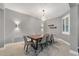 Stylish dining room featuring modern lighting, a large table, and neutral tones, ideal for gatherings at 32554 Silvercreek Way, Wesley Chapel, FL 33545