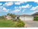 Charming single Gathering home features a paved driveway, three-car garage, and well-manicured lawn at 32554 Silvercreek Way, Wesley Chapel, FL 33545