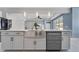 Farmhouse sink in the kitchen island with stainless steel appliances, sleek cabinetry, and modern fixtures at 32554 Silvercreek Way, Wesley Chapel, FL 33545
