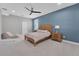 Calm main bedroom with a light wood bed, matching nightstands, and plush carpeting for added comfort at 32554 Silvercreek Way, Wesley Chapel, FL 33545