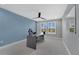 Well-lit office space with a modern desk, ceiling fan, and large window offering plenty of natural light at 32554 Silvercreek Way, Wesley Chapel, FL 33545