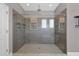 Modern walk-in shower with sleek glass enclosure and tiled walls, offering a spa-like experience at 32554 Silvercreek Way, Wesley Chapel, FL 33545