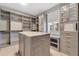 Spacious walk-in closet with custom shelving, drawers, and a central island for organization at 32554 Silvercreek Way, Wesley Chapel, FL 33545