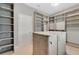 Well-organized walk-in closet with ample shelving and storage solutions, including a center island at 32554 Silvercreek Way, Wesley Chapel, FL 33545