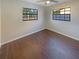 Bedroom with wood-look flooring and natural light at 701 71St N Ave, St Petersburg, FL 33702