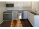 Modern kitchen featuring white cabinets, countertops, stainless steel appliances, and tile backsplash at 701 71St N Ave, St Petersburg, FL 33702
