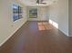 Open-concept living area showcasing hardwood floors and ample natural light from large windows at 701 71St N Ave, St Petersburg, FL 33702