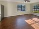 Bright living room features tile floors, a ceiling fan, and two windows providing natural light at 701 71St N Ave, St Petersburg, FL 33702