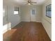 Bright living room featuring wood-look flooring, fan and multiple windows at 701 71St N Ave, St Petersburg, FL 33702