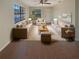 Bright living room featuring large windows, hardwood floors, and comfortable beige furnishings at 701 71St N Ave, St Petersburg, FL 33702