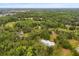 Distant aerial view showcasing the property in a wooded area at 10809 Cedar Cove Drive, Thonotosassa, FL 33592