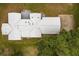 Aerial view of sprawling single-story home featuring light metal roof and mature landscaping at 10809 Cedar Cove Drive, Thonotosassa, FL 33592