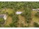 Expansive aerial view of estate home and land showing lush landscape and trees at 10809 Cedar Cove Drive, Thonotosassa, FL 33592