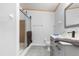 Neutral bathroom with gray tiling, walk-in shower, and vanity with gray drawers at 10809 Cedar Cove Drive, Thonotosassa, FL 33592