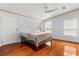 Bright bedroom featuring hardwood floors, a ceiling fan, and two windows at 10809 Cedar Cove Drive, Thonotosassa, FL 33592