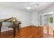 Bright room with hardwood floors, ceiling fan, and baby grand piano adds charm to this space at 10809 Cedar Cove Drive, Thonotosassa, FL 33592