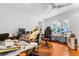 Spacious office area with hardwood floors, bright natural light, and ceiling fan at 10809 Cedar Cove Drive, Thonotosassa, FL 33592