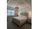 Comfortable bedroom featuring decorative trim, recessed lighting, and a large window dressed with plantation shutters at 1427 Hyssop Loop, North Port, FL 34289