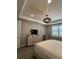 Bright bedroom with a stylish ceiling light, large dresser with TV, plantation shutters, and neutral decor at 1427 Hyssop Loop, North Port, FL 34289
