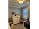 Charming bedroom features shuttered windows, a dresser, and wicker chairs at 1427 Hyssop Loop, North Port, FL 34289