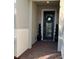 Close-up of front entrance with brick floor, decorative wreath on door, and potted topiaries at 1427 Hyssop Loop, North Port, FL 34289