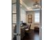 Charming home office featuring french doors, dark wood floors, and a window with plantation shutters at 1427 Hyssop Loop, North Port, FL 34289
