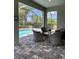 Screened-in lanai with brick pavers overlooks the pool with ample seating at 1427 Hyssop Loop, North Port, FL 34289