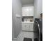 Laundry room features white cabinets above the sink and next to the washer/dryer at 1427 Hyssop Loop, North Port, FL 34289