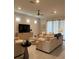 Comfortable living room with neutral tones, plantation shutters, tile floor, and modern furnishings at 1427 Hyssop Loop, North Port, FL 34289