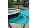 Beautiful pool and spa combination features a waterfall and brick trim at 1427 Hyssop Loop, North Port, FL 34289