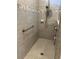 Modern tiled shower with grab bar and shower accessories at 1427 Hyssop Loop, North Port, FL 34289