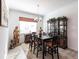 Formal dining room with dark wood table and chairs, hardwood floors, and elegant china cabinet at 25301 Longmeadow Dr, Punta Gorda, FL 33955