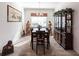 Formal dining area featuring a chandelier, statues, and large display cabinet perfect for dinner parties at 25301 Longmeadow Dr, Punta Gorda, FL 33955