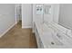 Bathroom featuring double sinks, quartz counters and mirrors at 4914 Trinidad Dr, Land O Lakes, FL 34639