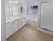Bathroom featuring a double vanity, soaking tub, tiled floors, and walk in shower at 4914 Trinidad Dr, Land O Lakes, FL 34639
