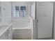 Bathroom featuring a soaking tub, glass-enclosed shower, and modern fixtures at 4914 Trinidad Dr, Land O Lakes, FL 34639
