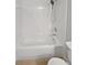Close-up of a bathtub and shower area in an all-white bathroom at 4914 Trinidad Dr, Land O Lakes, FL 34639