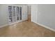 Bedroom with tile floors, open doors to the hallway and covered patio at 4914 Trinidad Dr, Land O Lakes, FL 34639