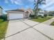 Charming home featuring a well-maintained front yard and a wide driveway at 4914 Trinidad Dr, Land O Lakes, FL 34639
