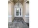 Inviting entryway with decorative glass door and paved walkway at 4914 Trinidad Dr, Land O Lakes, FL 34639