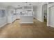 Open kitchen with white cabinets, updated lighting, and a breakfast bar at 4914 Trinidad Dr, Land O Lakes, FL 34639