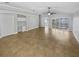 A well-lit living room with a ceiling fan and neutral tile flooring at 4914 Trinidad Dr, Land O Lakes, FL 34639
