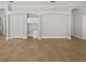 Spacious living room featuring built-in shelving and neutral tile flooring at 4914 Trinidad Dr, Land O Lakes, FL 34639