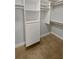 Organized walk-in closet with built-in shelving and drawers, offering ample storage space at 4914 Trinidad Dr, Land O Lakes, FL 34639