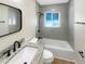 Updated bathroom features gray tile and updated fixtures at 961 Charlotte Ave, Sarasota, FL 34237