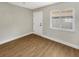 Empty bedroom with wood-look floors, a ceiling fan, and a bright window, perfect for customization at 961 Charlotte Ave, Sarasota, FL 34237