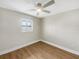 Cozy bedroom features wood-look floors, a window, and a ceiling fan at 961 Charlotte Ave, Sarasota, FL 34237