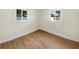 Bedroom featuring wood-look floors and natural light from two windows at 961 Charlotte Ave, Sarasota, FL 34237