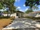 Front exterior of a newly renovated home, landscaped yard, with a concrete driveway and white fence at 961 Charlotte Ave, Sarasota, FL 34237