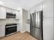 Modern kitchen features stainless steel appliances and white cabinets at 961 Charlotte Ave, Sarasota, FL 34237